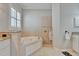 Bright bathroom with soaking tub, granite counters, and a tiled shower at 2464 Laurel Glen Dr, Lakeland, FL 33803