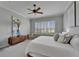 Inviting bedroom with natural light from shuttered windows, a dresser, and artwork at 2464 Laurel Glen Dr, Lakeland, FL 33803