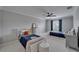 Bedroom with two beds, ceiling fan, neutral walls, and natural light from the window at 2464 Laurel Glen Dr, Lakeland, FL 33803