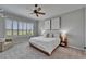 Bright bedroom showcasing a large window with shutters, a ceiling fan, and neutral tones at 2464 Laurel Glen Dr, Lakeland, FL 33803