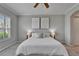 Stylish bedroom with plush bedding, a ceiling fan, and soft, neutral colors at 2464 Laurel Glen Dr, Lakeland, FL 33803