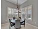 Bright dining room featuring a modern light fixture, a dark wood table, and natural lighting at 2464 Laurel Glen Dr, Lakeland, FL 33803