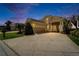 Stunning home exterior with an expansive driveway, tile roof, and lush, tropical landscaping for curb appeal at 2464 Laurel Glen Dr, Lakeland, FL 33803