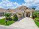 Beautiful two-story home with a tile roof, a spacious driveway, and lush landscaping at 2464 Laurel Glen Dr, Lakeland, FL 33803