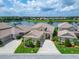 Stunning lakefront home featuring a paver driveway, a tile roof, and manicured landscaping at 2464 Laurel Glen Dr, Lakeland, FL 33803
