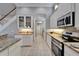 Galley kitchen showcasing granite countertops, stainless steel appliances, and white cabinets at 2464 Laurel Glen Dr, Lakeland, FL 33803