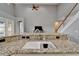 Bright kitchen featuring granite countertops, a stainless steel sink, and open floor plan at 2464 Laurel Glen Dr, Lakeland, FL 33803