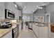 Modern kitchen showcasing stainless appliances, granite counters, white cabinets, and plenty of space at 2464 Laurel Glen Dr, Lakeland, FL 33803