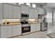Modern kitchen featuring stainless steel appliances, white cabinets, granite countertops, and a tiled floor at 2464 Laurel Glen Dr, Lakeland, FL 33803