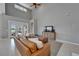 Open-concept living room with high ceilings, tiled floors, comfortable sofa, and natural light at 2464 Laurel Glen Dr, Lakeland, FL 33803