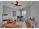 Comfortable office space features a ceiling fan, a window, wood floors, and comfortable leather furniture at 2464 Laurel Glen Dr, Lakeland, FL 33803
