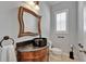 Elegant powder room featuring a vessel sink, granite countertop, and decorative mirror at 2464 Laurel Glen Dr, Lakeland, FL 33803