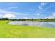 Expansive water view with well maintained lawn and surrounding landscaping at 2464 Laurel Glen Dr, Lakeland, FL 33803