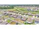 Aerial view of a neighborhood, showcasing uniform gray homes and an interconnected street system with roundabouts at 2546 Red Egret Dr, Bartow, FL 33830