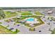 Aerial view of a community pool, playground, and ample parking nestled within a residential area at 2546 Red Egret Dr, Bartow, FL 33830