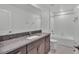 Bathroom with granite countertop and a bathtub with shower, all in neutral colors at 2546 Red Egret Dr, Bartow, FL 33830