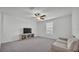 Spacious carpeted bedroom with a ceiling fan and a seating area at 2546 Red Egret Dr, Bartow, FL 33830