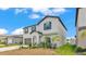 Exterior view of a two-story gray home with blue shutters and a well-manicured front yard at 2546 Red Egret Dr, Bartow, FL 33830