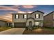Two-story home featuring neutral paint, black shutters, arched entryway, and an attached two-car garage at 2546 Red Egret Dr, Bartow, FL 33830