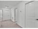 Hallway with multiple access doors and carpeted flooring leading to various rooms at 2546 Red Egret Dr, Bartow, FL 33830