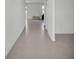 Hallway with neutral paint, new tile floor, and doors leading to various rooms at 2546 Red Egret Dr, Bartow, FL 33830
