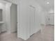 Hallway with neutral paint, new tile floor, and doors leading to various rooms at 2546 Red Egret Dr, Bartow, FL 33830
