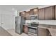 Bright kitchen with stainless appliances, granite countertops, and brown cabinets at 2546 Red Egret Dr, Bartow, FL 33830