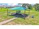 Community playground featuring a shaded play structure, benches, and a mulch ground cover at 2546 Red Egret Dr, Bartow, FL 33830
