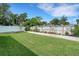 Spacious backyard with lush green lawn, wood fence, and garden beds at 2731 Coventry Ave, Lakeland, FL 33803