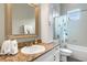 Bathroom with granite countertop, beadboard cabinets, and decorative mirror frame and shower at 2731 Coventry Ave, Lakeland, FL 33803