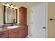 Bathroom features granite countertops, wooden cabinets, a large mirror, and a separate linen closet at 2731 Coventry Ave, Lakeland, FL 33803