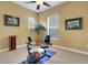 This workout room features a plant, artwork, and a ceiling fan at 2731 Coventry Ave, Lakeland, FL 33803