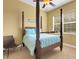 Bedroom with four poster bed, ceiling fan, and a window overlooking the exterior at 2731 Coventry Ave, Lakeland, FL 33803