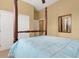 Spacious bedroom with a four-poster bed and an adjacent view into the upstairs hallway at 2731 Coventry Ave, Lakeland, FL 33803