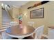 Dining area featuring a round wood table, a flamingo statue, and open access to the stairs at 2731 Coventry Ave, Lakeland, FL 33803