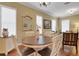 Dining room showcasing a round table, cream chairs, and natural light from window at 2731 Coventry Ave, Lakeland, FL 33803