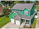Charming two-story home with stone accents, attached garage, and welcoming front porch at 2731 Coventry Ave, Lakeland, FL 33803
