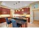 Open kitchen boasts dark wood cabinets, granite counters, and pendant lighting at 2731 Coventry Ave, Lakeland, FL 33803