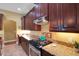 The kitchen features granite countertops, a cooktop, and ample cabinet space at 2731 Coventry Ave, Lakeland, FL 33803