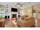Bright and spacious living room featuring a fireplace, built-in shelving, and hardwood floors at 2731 Coventry Ave, Lakeland, FL 33803