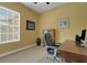 This office features a wooden desk, rolling chair, and large window at 2731 Coventry Ave, Lakeland, FL 33803