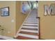 Stairway with wooden railing and white risers featuring a sunny window at 2731 Coventry Ave, Lakeland, FL 33803