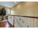 Second floor landing with hardwood floors, a window and white railing at 2731 Coventry Ave, Lakeland, FL 33803