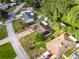 Bright aerial view of a neighborhood showcasing mature landscaping and a serene canal running behind several homes at 2757 Pine Acres Dr, Lake Wales, FL 33898