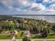 Wonderful aerial view of a waterfront neighborhood with mature landscaping near a lake on a partly cloudy day at 2757 Pine Acres Dr, Lake Wales, FL 33898