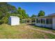 Expansive backyard showcasing a shed, dog kennel, and a covered patio for outdoor enjoyment at 2757 Pine Acres Dr, Lake Wales, FL 33898