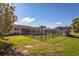 Large, fenced backyard features plenty of green space, a shed, and a dog kennel at 2757 Pine Acres Dr, Lake Wales, FL 33898