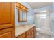 Bathroom with a wood vanity, a shower/tub combo, and stylish lighting at 2757 Pine Acres Dr, Lake Wales, FL 33898