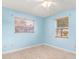 The freshly painted bedroom offers tiled floors, window blinds, and ample natural light at 2757 Pine Acres Dr, Lake Wales, FL 33898