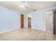 The bright bedroom offers tiled floors, fresh paint, a ceiling fan, and access to a walk-in closet at 2757 Pine Acres Dr, Lake Wales, FL 33898